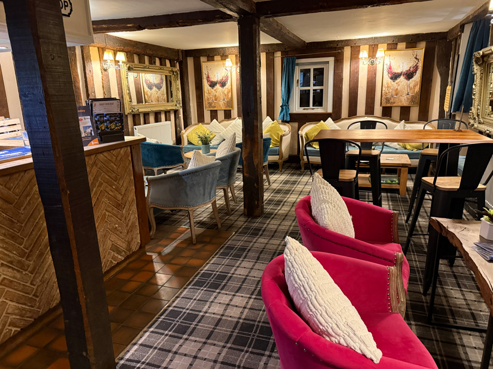 Cosy snug bar with open fire at a Cambridge wedding venue